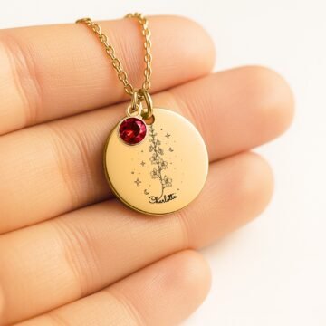 Close-up of july carnation necklace with personalized name engraving and july birthstone charm