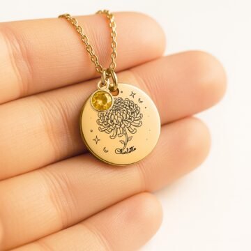 Close-up of november carnation necklace with personalized name engraving and november birthstone charm