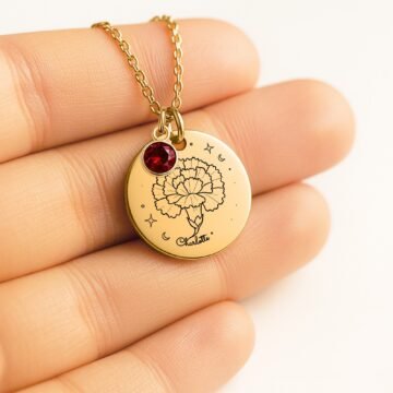 Personalized carnation pendant necklace shown in hand for scale