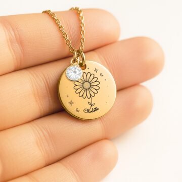 Personalized daisy pendant necklace shown in hand for scale