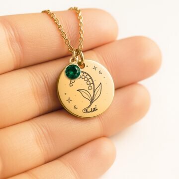 Personalized lily-of-the-valley pendant necklace shown in hand for scale